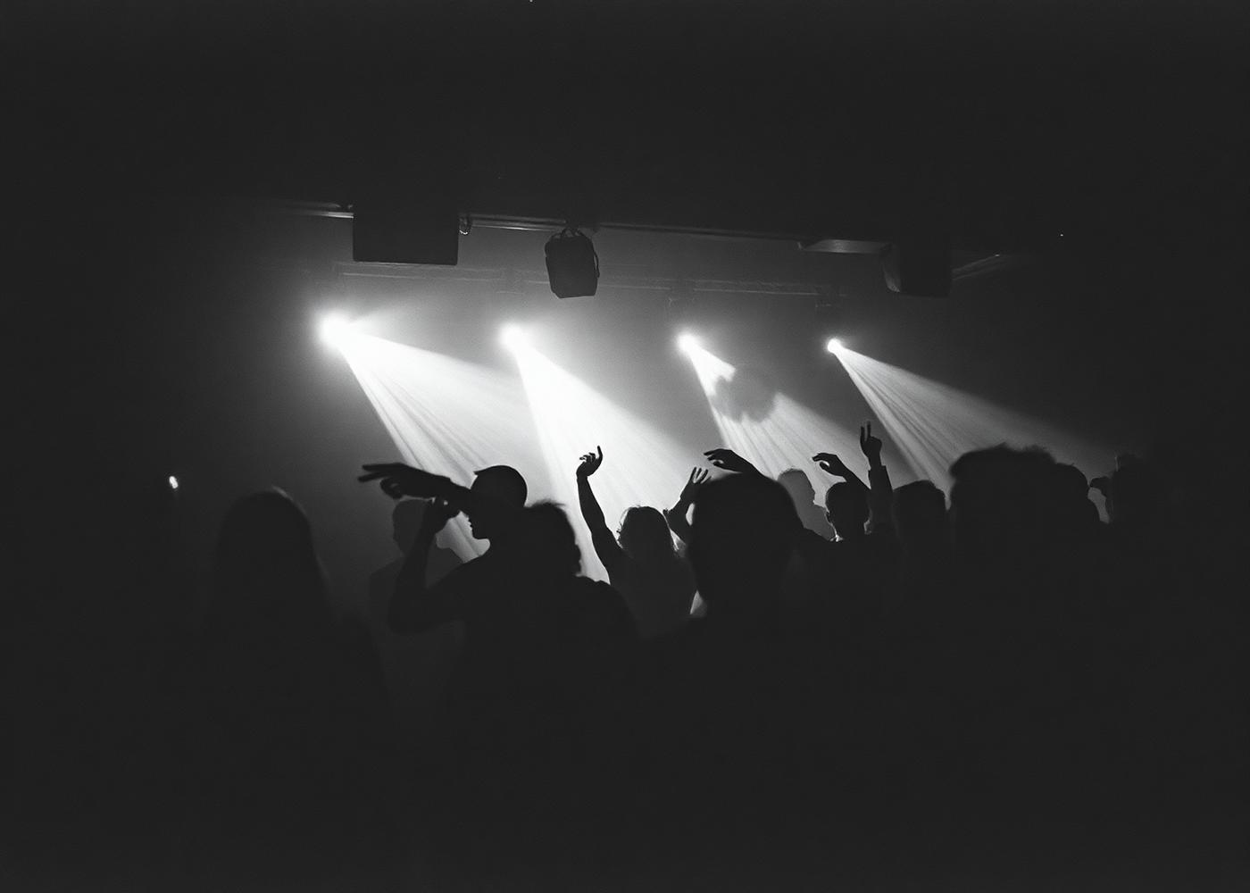 Silhouetted crowd under strobe lights in a Belgian club